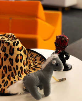 cowboy hat, fluffy horse and darth vader on a table